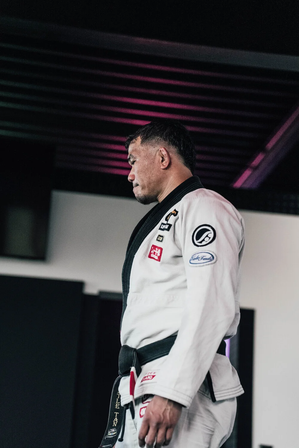 BJJ-Athlet im weißen Gi mit schwarzem Gürtel